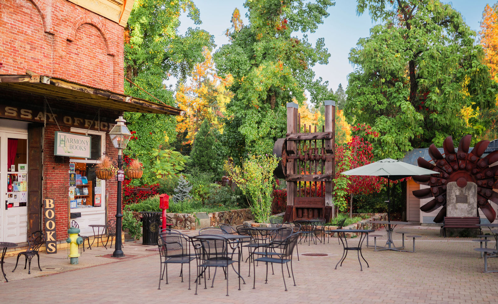 Brick Assay Office building and bookshop on a downtown Nevada City plaza with an antique stamp mill and Pelton wheel