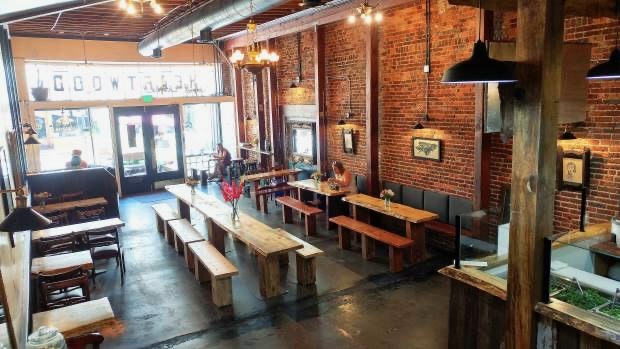 The brick interior and communal tables at Heartwood Eatery